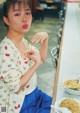 A woman sitting at a table with a bowl of food.