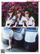 A group of young women in school uniforms posing for a picture.