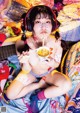 A woman sitting on a bed eating a bowl of food.