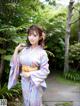 A woman in a kimono posing for a picture.