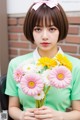 A woman holding a bunch of flowers in her hands.